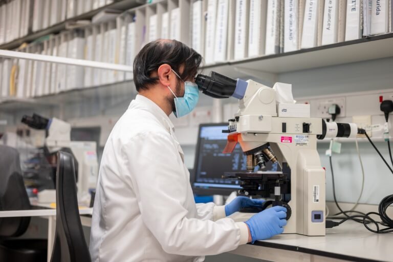 7415_Biomedical-scientist-looking-at-blood-film-on-microscope-1